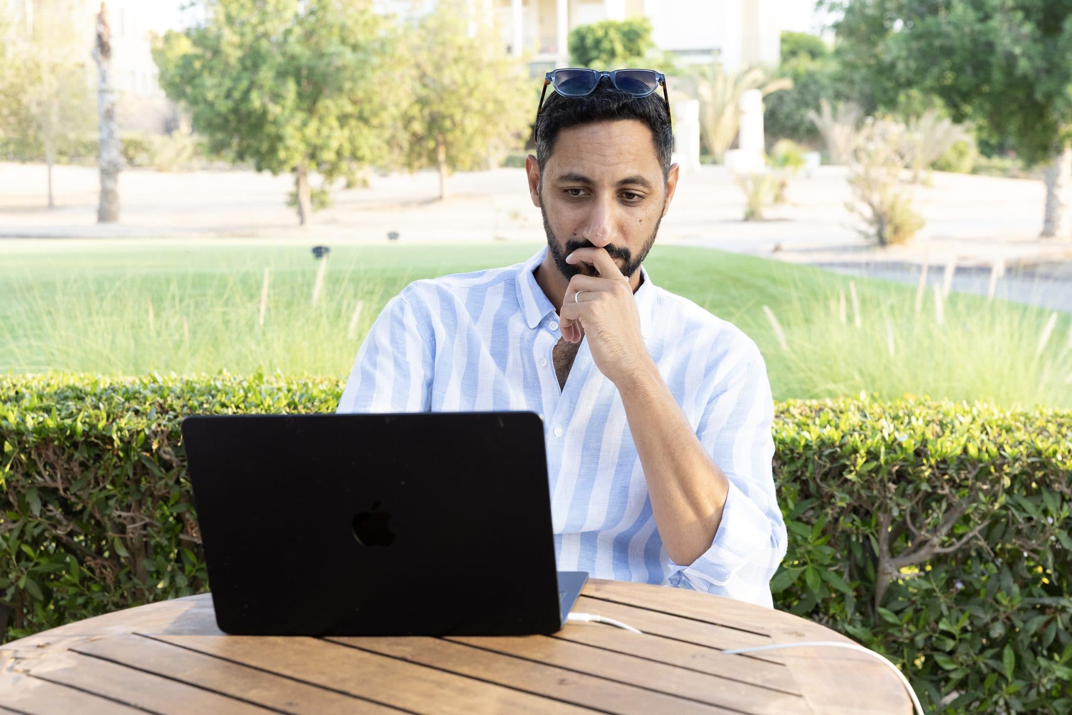 Ahmed Gheith thinking over his laptop